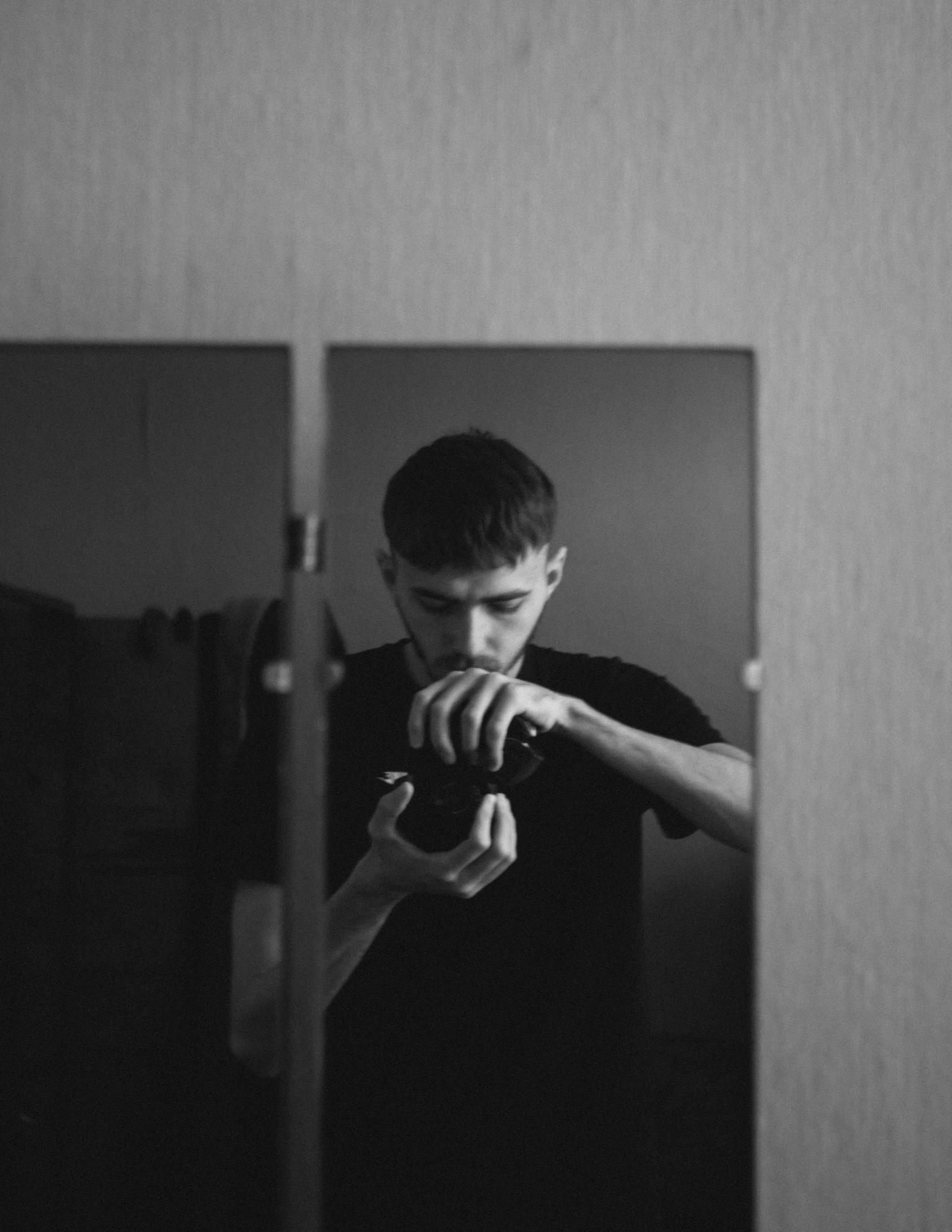 a young man taking a selfie in the mirror