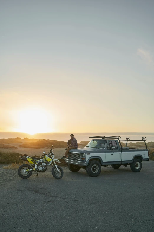 a pickup truck towing an off - road vehicle