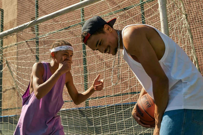 two people who are standing near the net