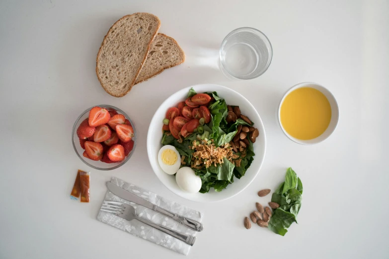 a white bowl filled with fruits and vegetables