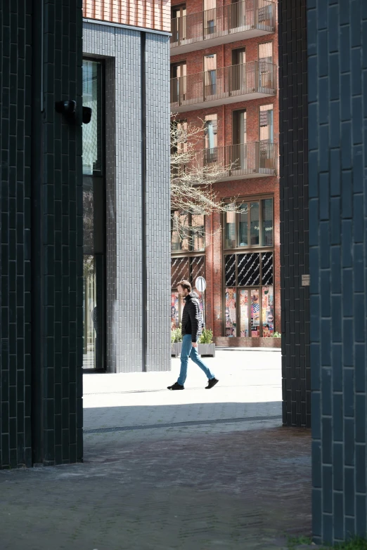 a person walks past a tall building in the distance