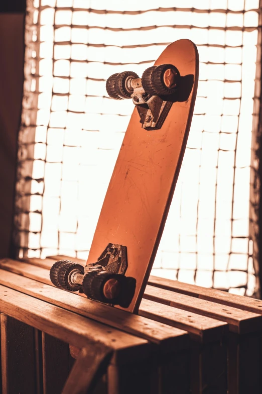 a skateboard on top of a table next to a window