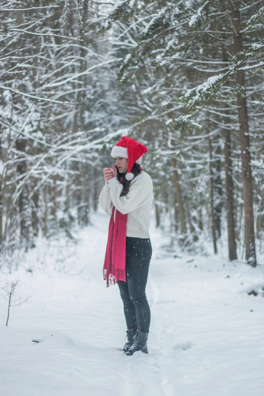 a woman wearing a red scarf is taking a po of her