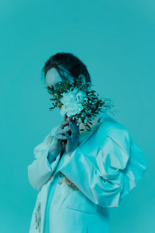 a woman wearing a white dress and flowers in her hair