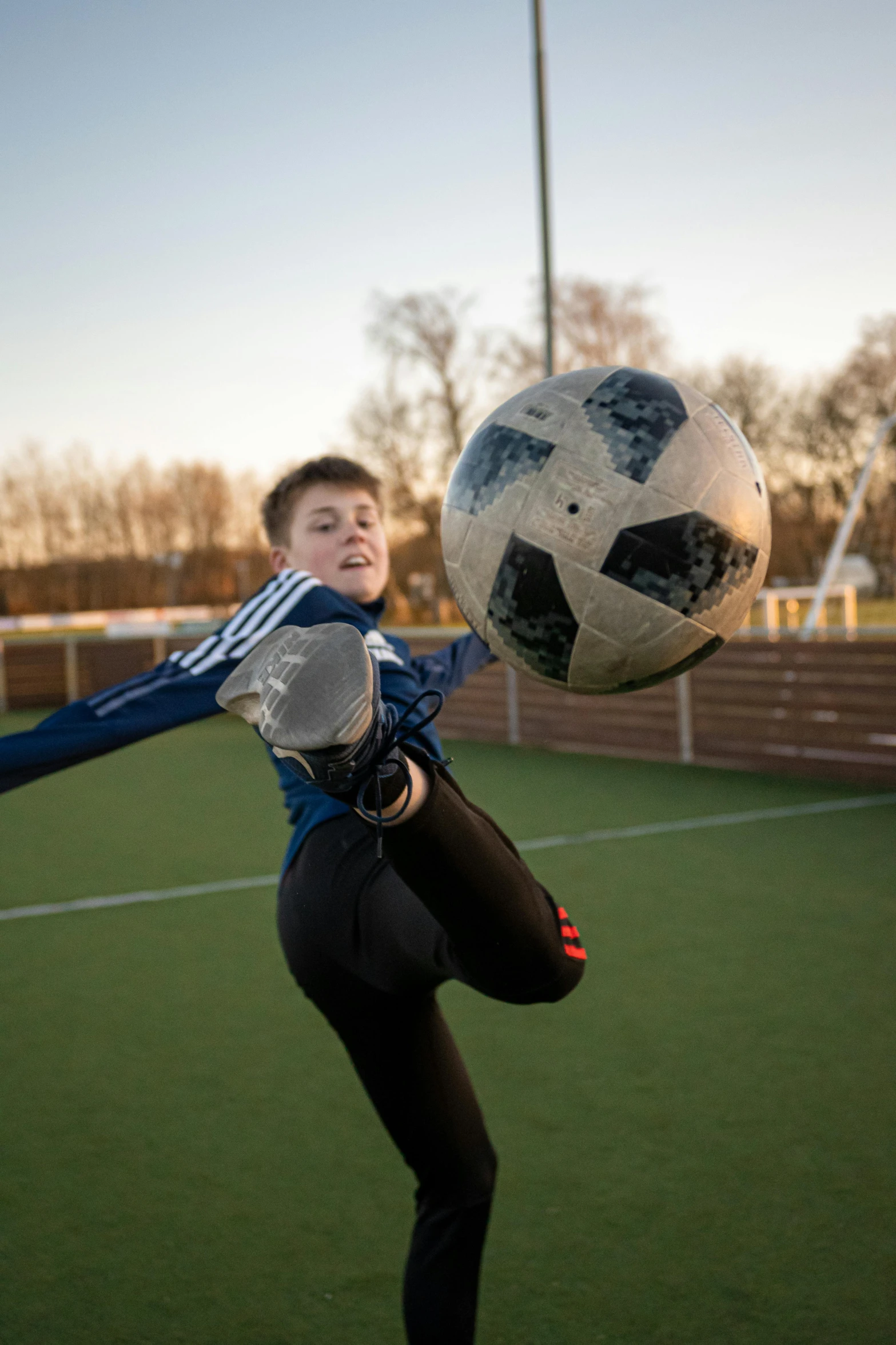 a person standing near a soccer ball on the grass