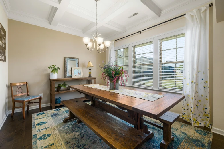 a brown table in front of large windows