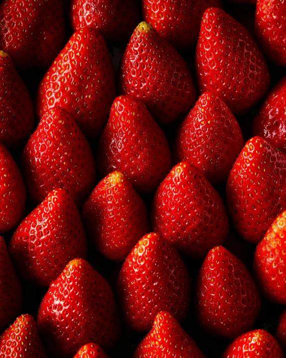 close up view of many strawberries stacked together