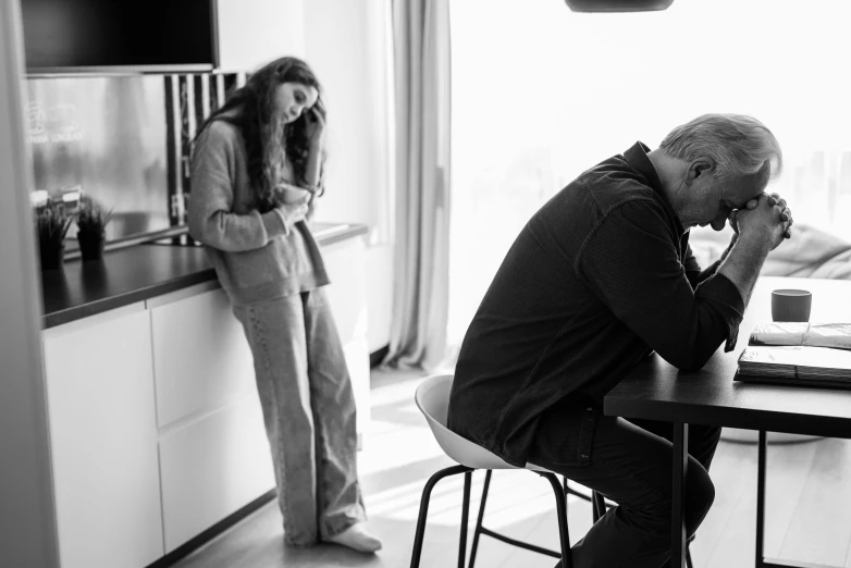 a man stands at the table next to a woman in a black and white po