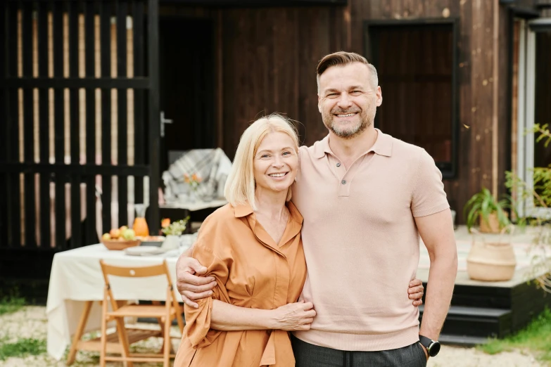 a woman and man pose for a po by some outdoor setting