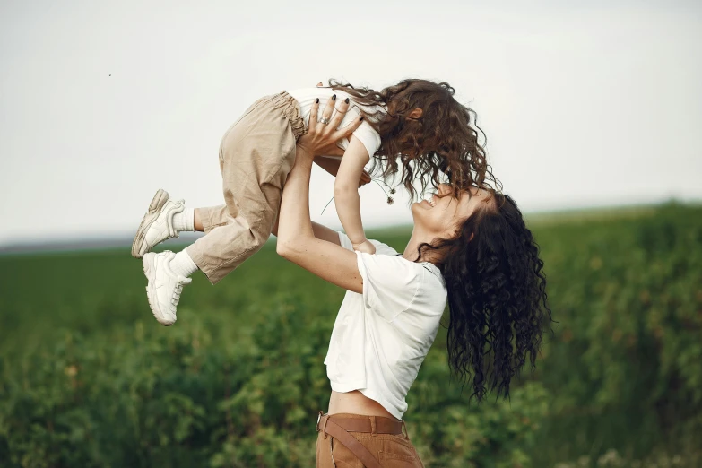 a mother and her child outdoors in a large field