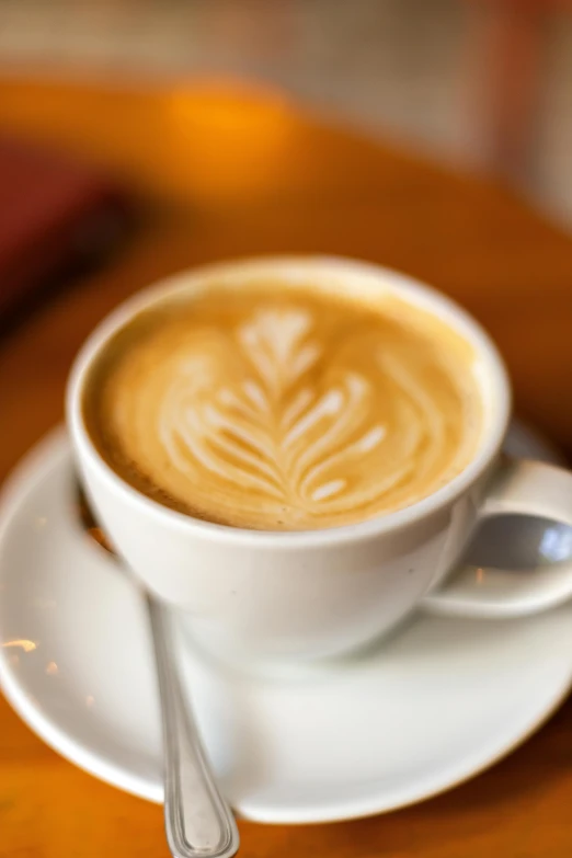 a cup of coffee with a spoon on top of a saucer