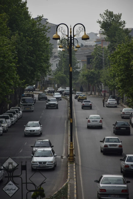 a street light with cars driving along the road