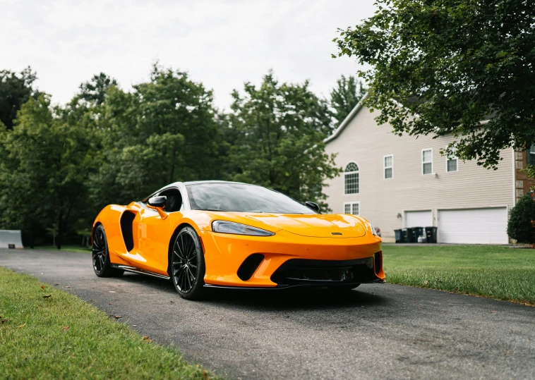 a sporty, sports car driving through the driveway