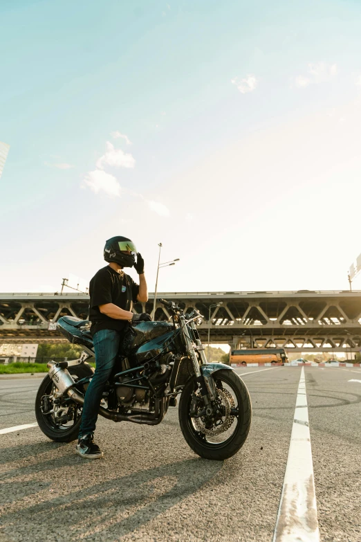 man sitting on motorcycle talking on his cellphone