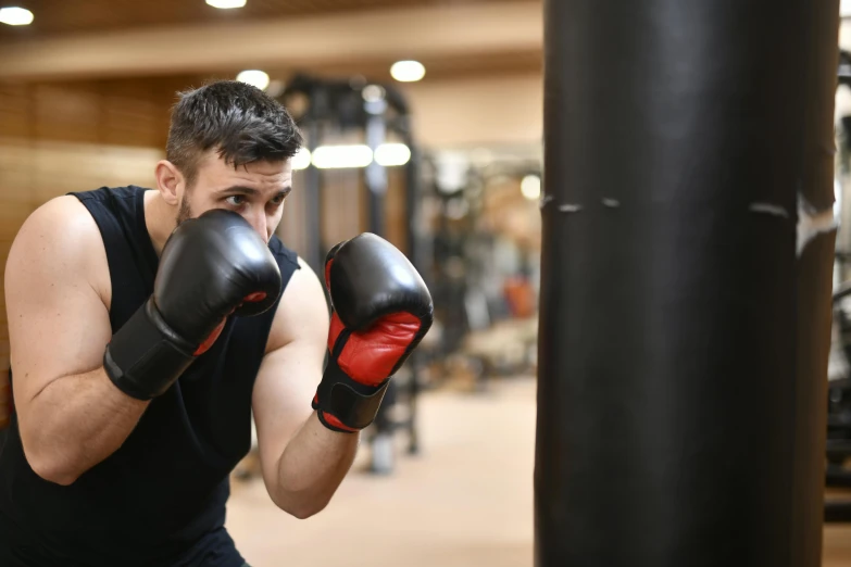 a man taking a stance with his boxing gloves on