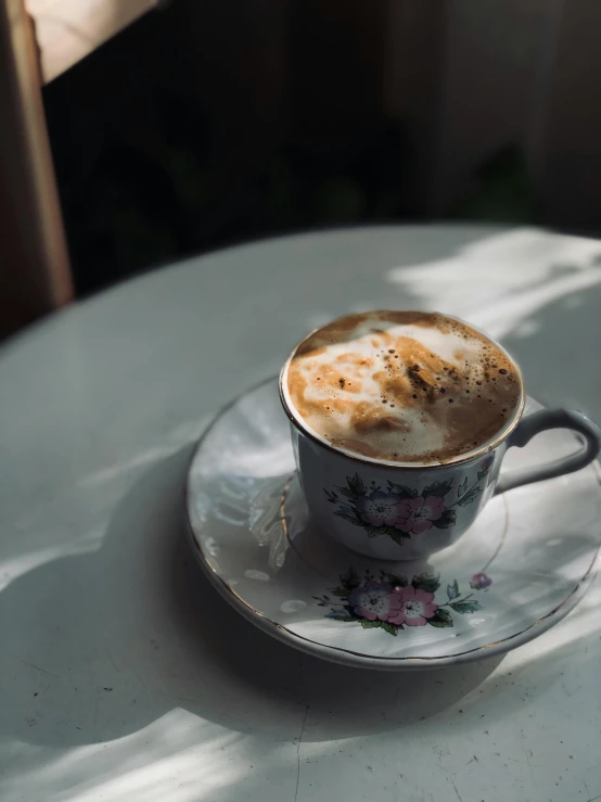 cappuccino on saucer setting on table outside