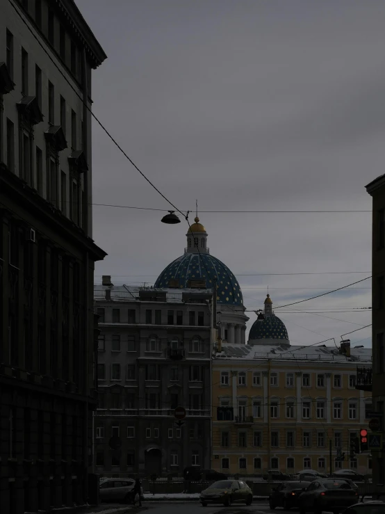 some buildings with cars and lights in the distance