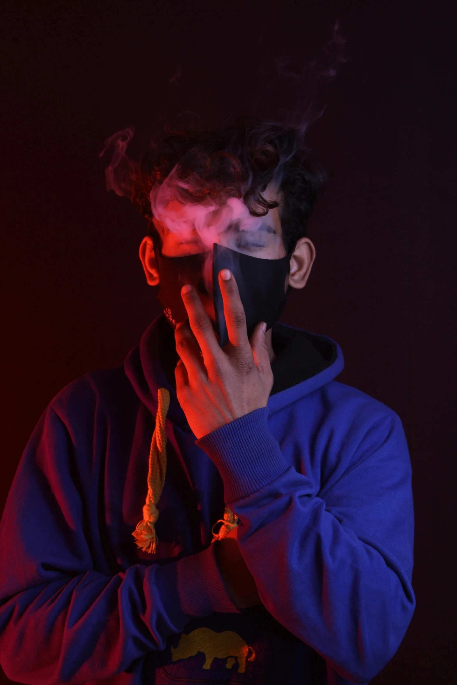 man smoking and covering his face with the word smoke