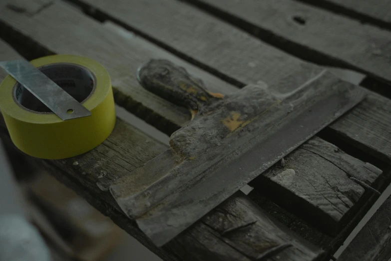 a piece of wood with a yellow plastic cup