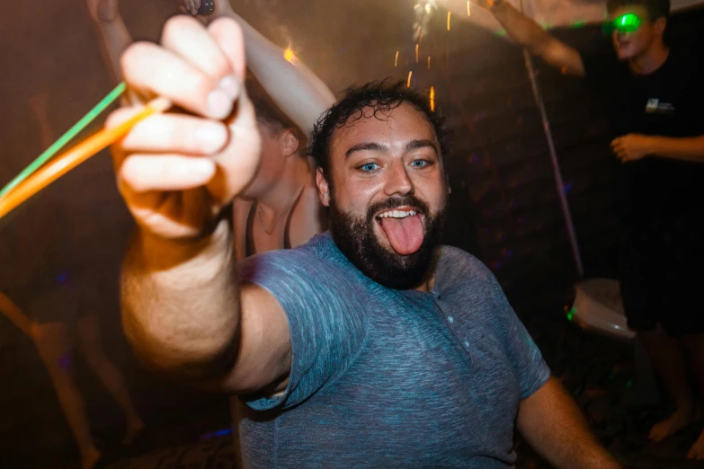 a man holding a plastic toothbrush in his right hand