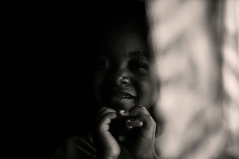 a little boy in the dark looking at the camera