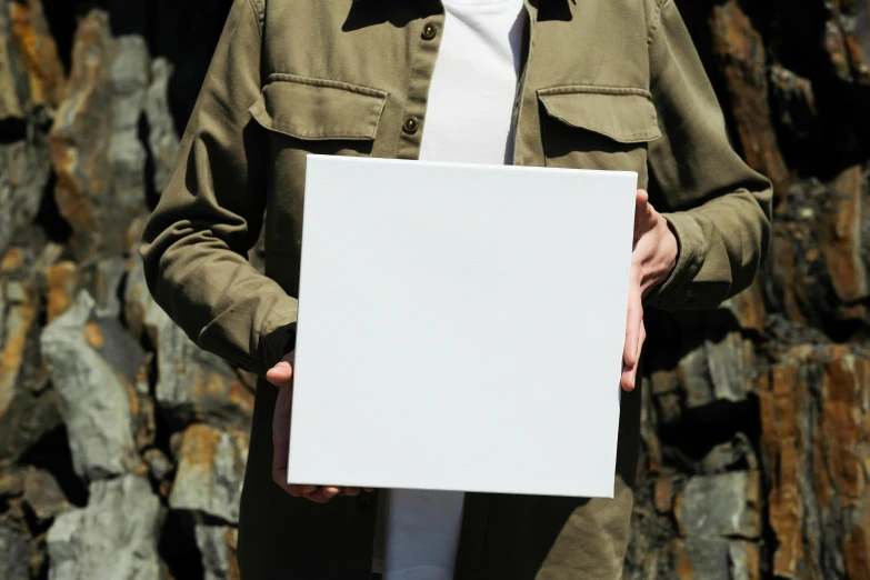 a person holding up a white piece of paper