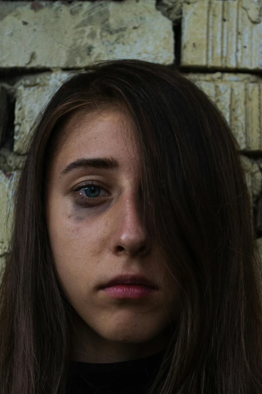 a woman with long hair looks to the side