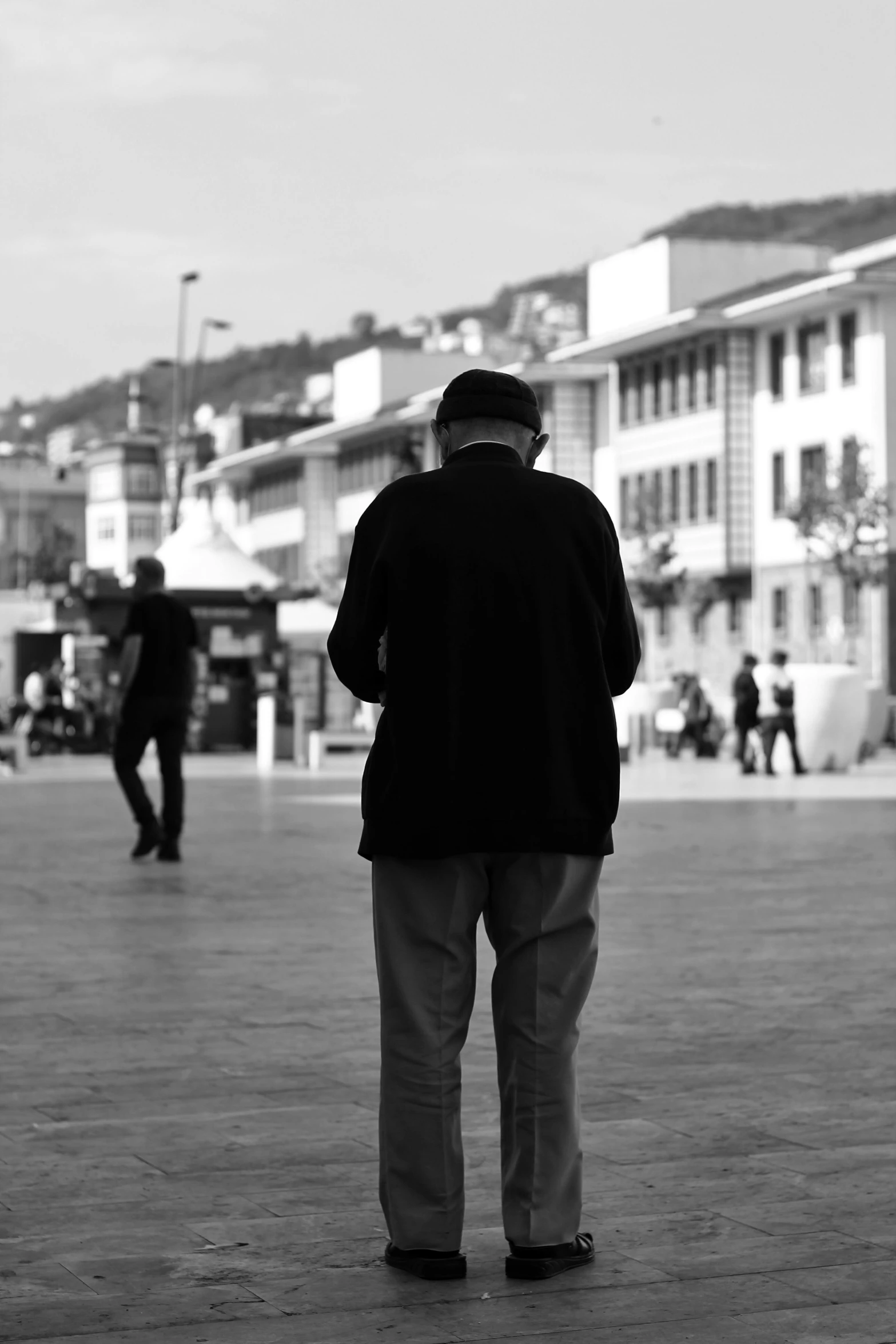 black and white pograph of a man looking at people