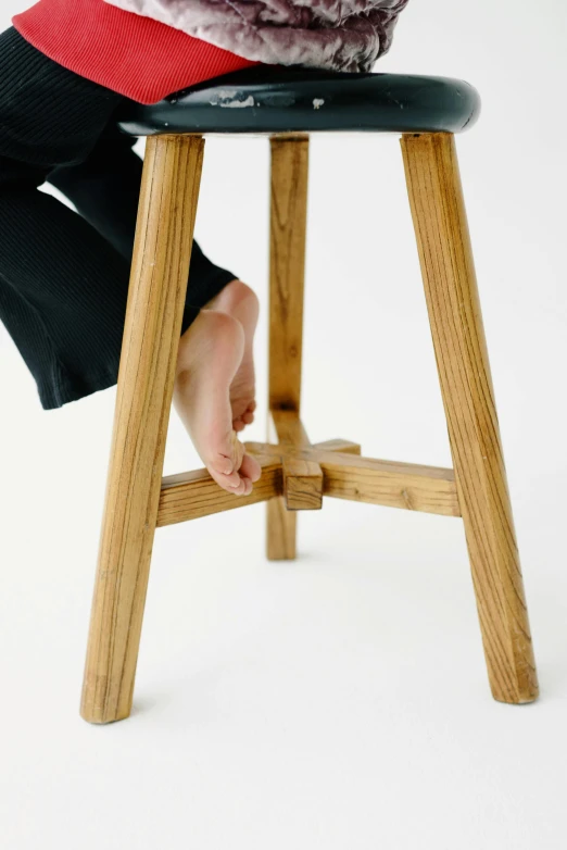 a person standing on a stool with their foot up