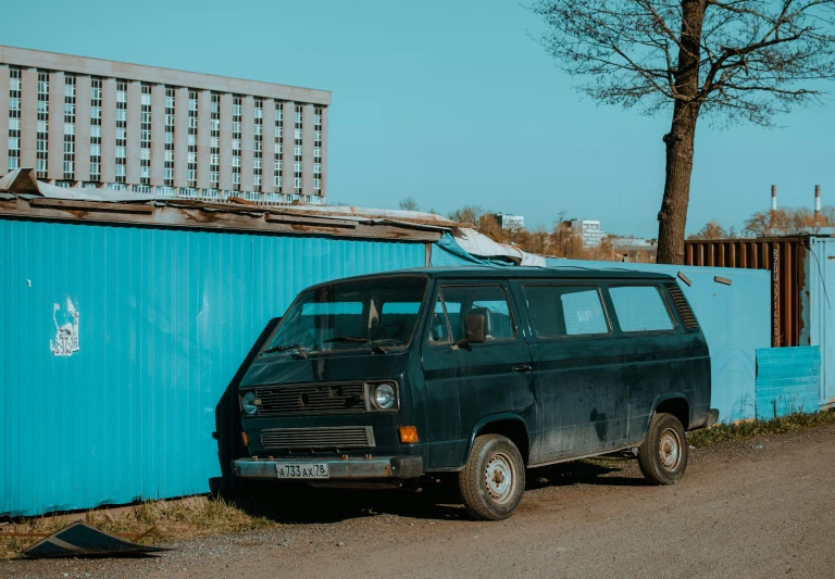 a car parked on a road next to a building