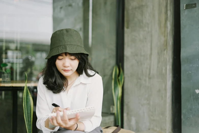 a woman is looking at her tablet while outside