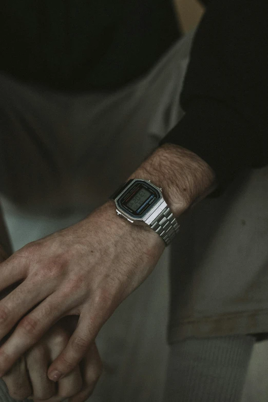 the watch on this man's wrist is silver