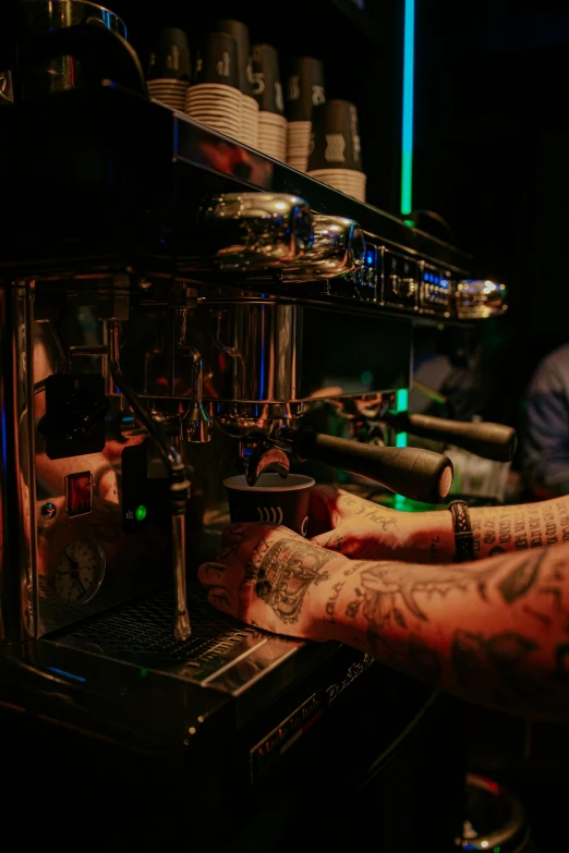 a man's arm with tattoo on, and a counter with cups