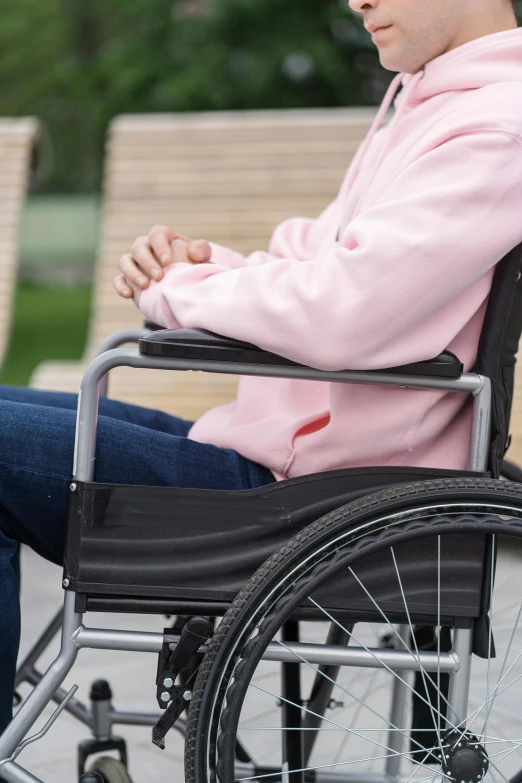 the man in the wheelchair is resting his arms folded