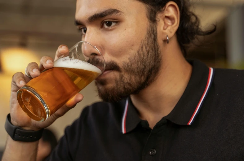 a man is drinking a beverage of some sort