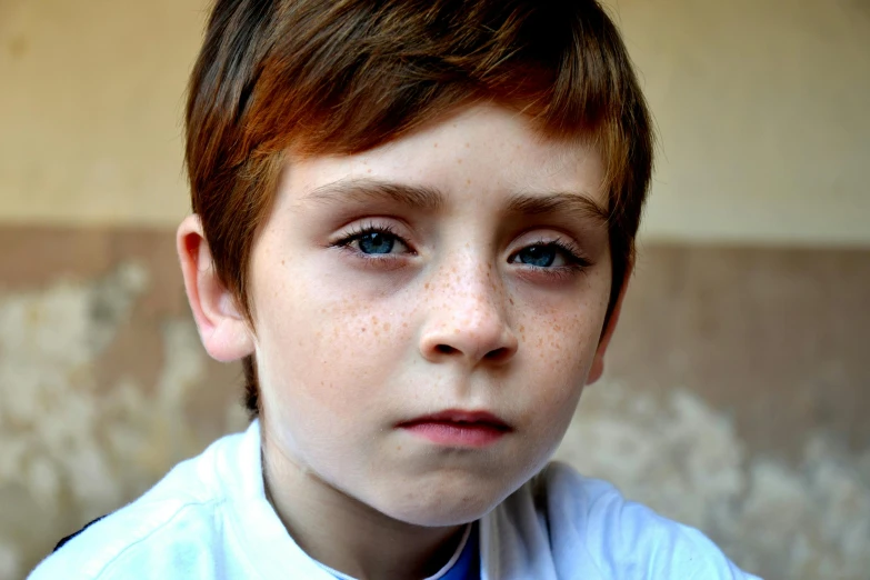 a little boy with red hair and blue eyes