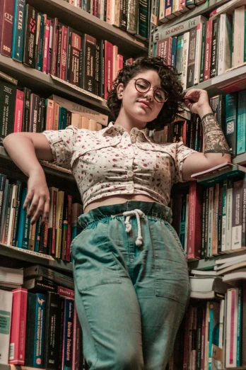 a woman is leaning up against a bookcase