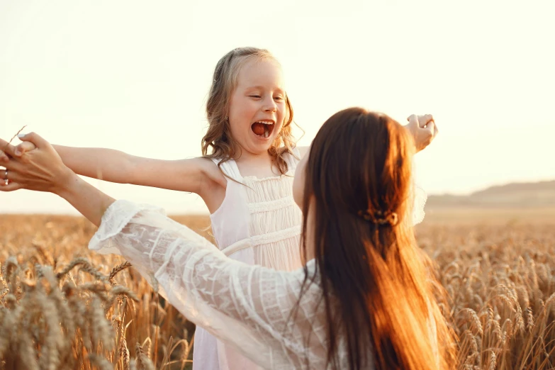 an adorable girl is standing with her hands in her ears