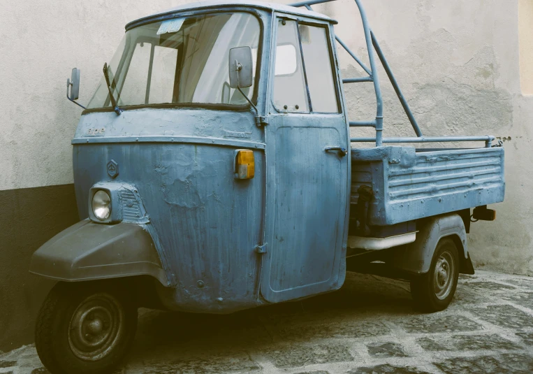 a blue van parked on the side of a building