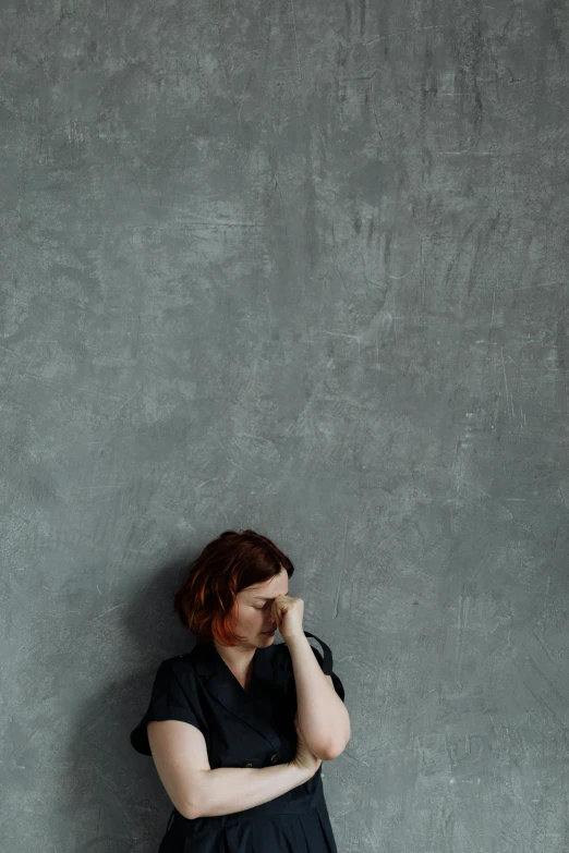 an image of a woman leaning against a wall