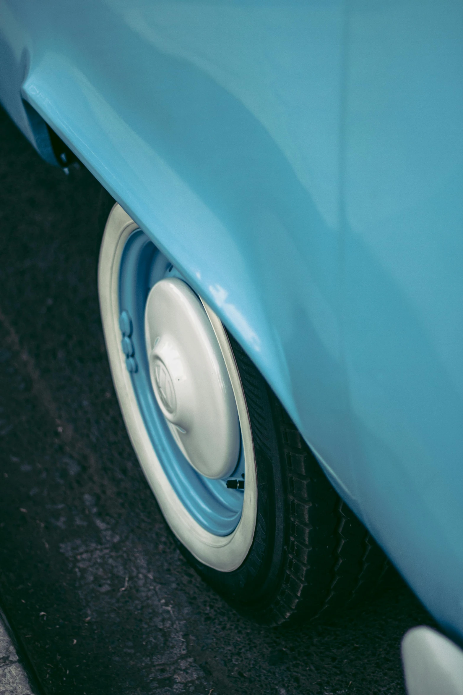 close up view of blue car tire with white spokes