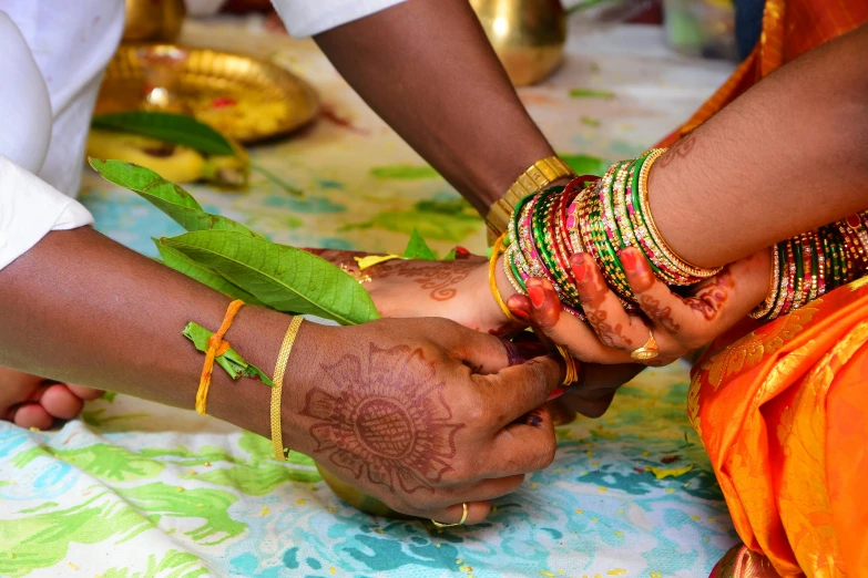 the women hold their hands together to make soing