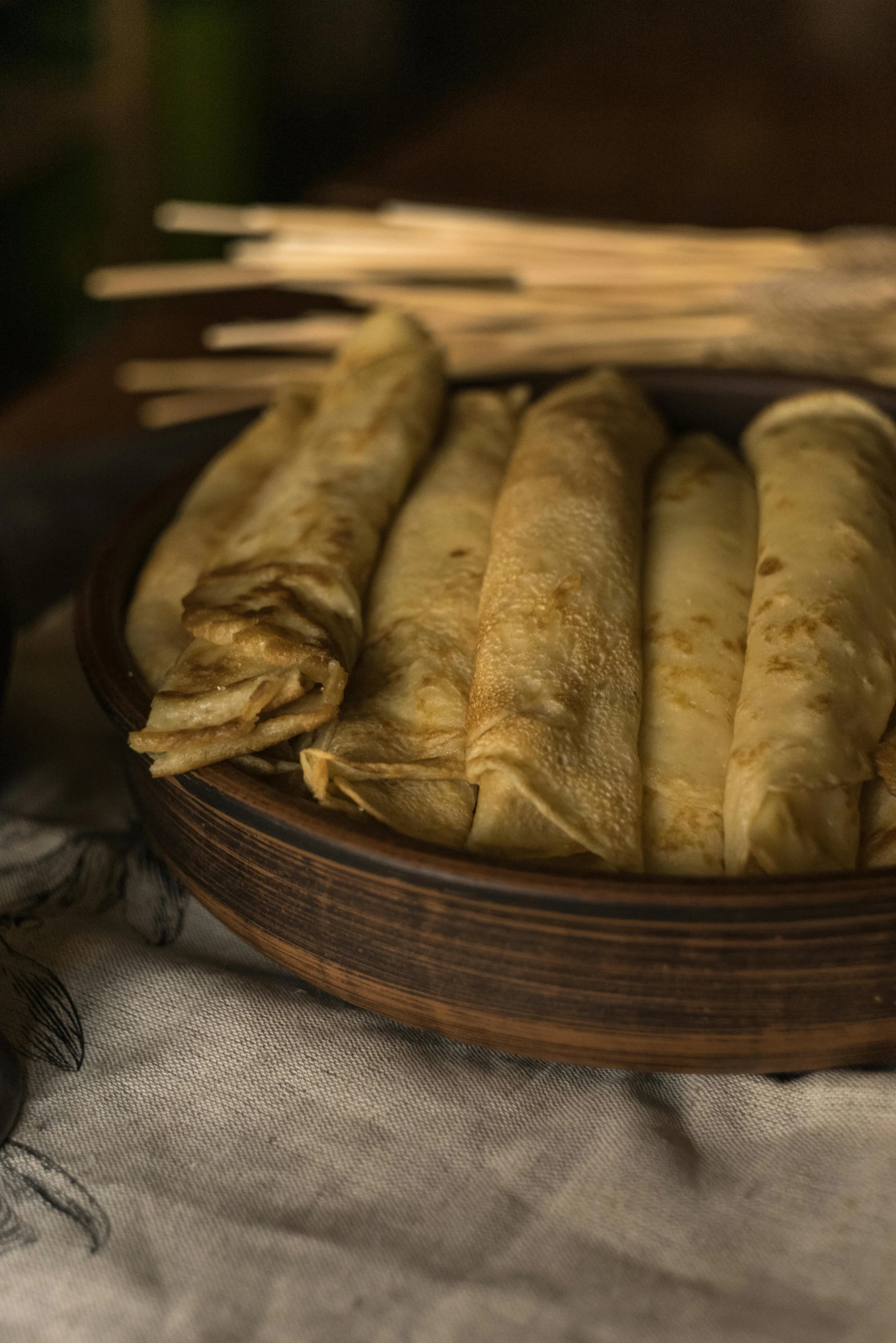 there are five long rolled burritos sitting on the tray