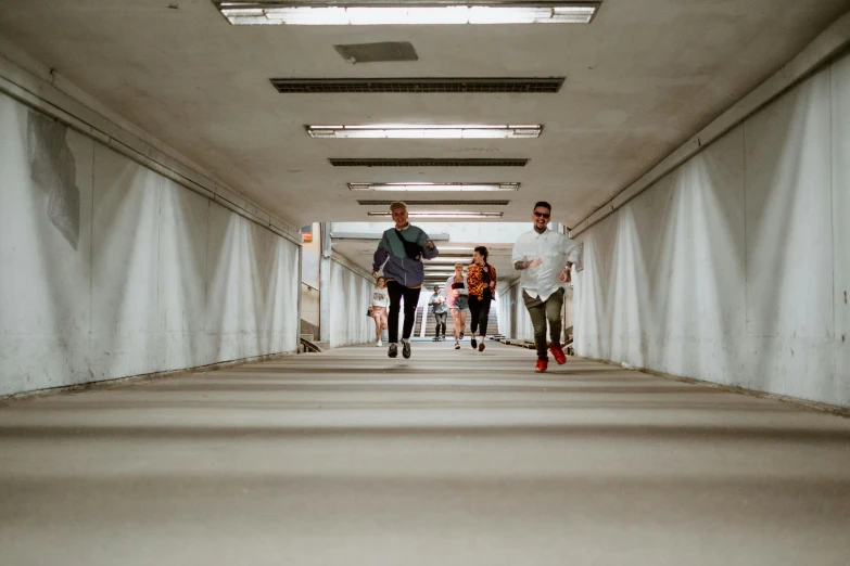 a group of people walking through a hallway