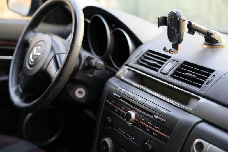 the dash board of an automobile with a air vent hanging over it