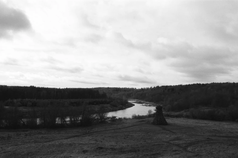 a river in a valley surrounded by trees