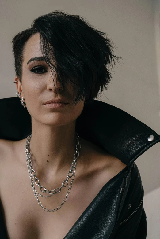 a woman in black is posing with her top on