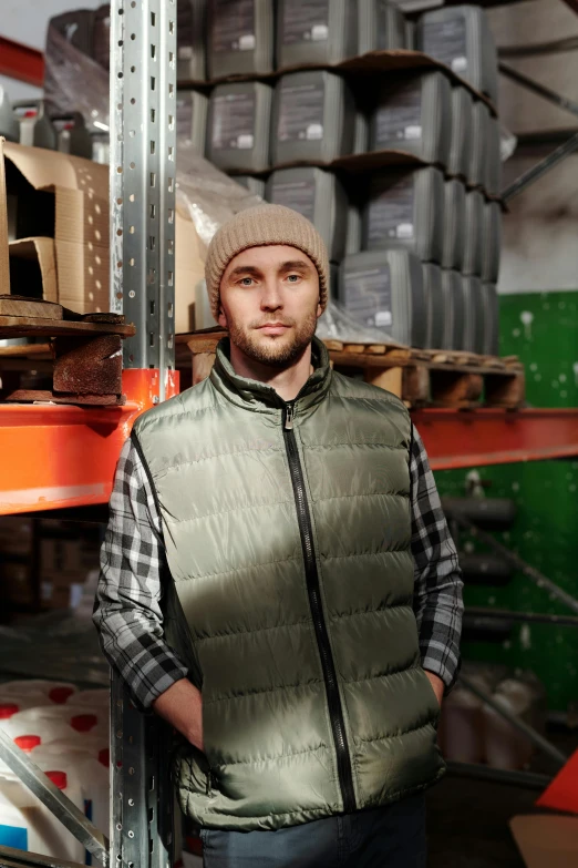 a man is standing in front of a metal rack