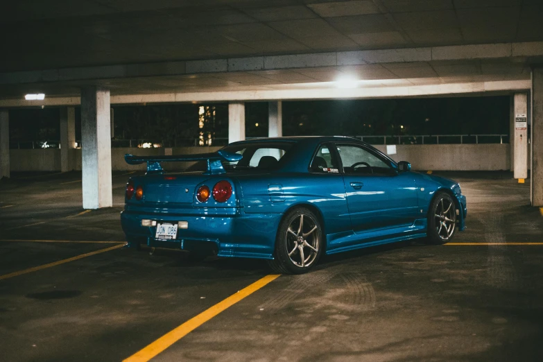 a blue car in a parking lot during the day