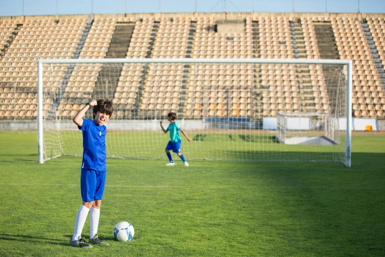 some boys playing soccer and having a ball